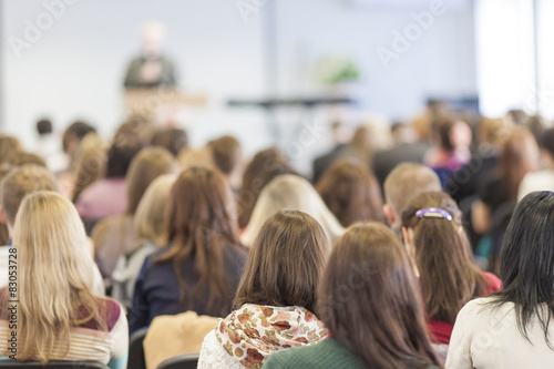 Lecturer Speaking In front of the Large Group of People
