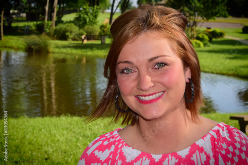 Environmental portrait of a young woman at a pond. 