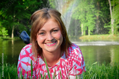 Environmental portrait of a young woman at a pond. 