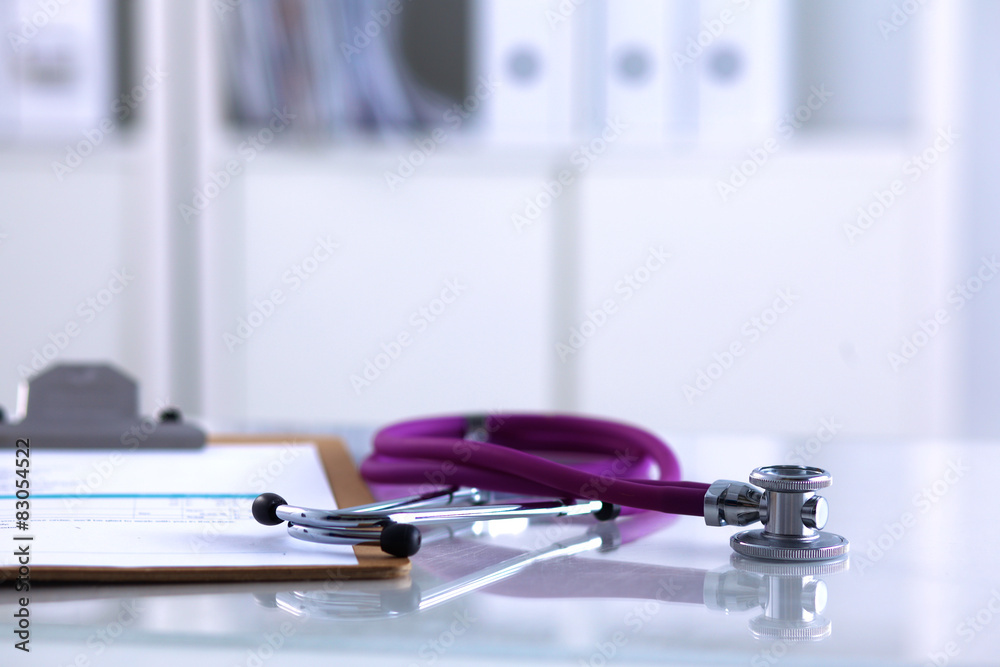 Doctor's stethoscope with folder on the desk Doctor's stethoscope with folder on the desk