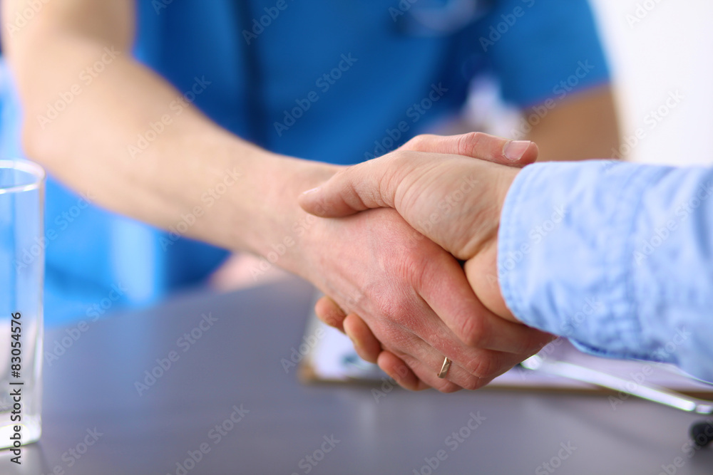 Doctor shakes hands with a patient Doctor shakes hands with a patient