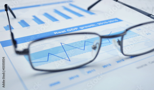 Glasses on financial chart and graph, success concept