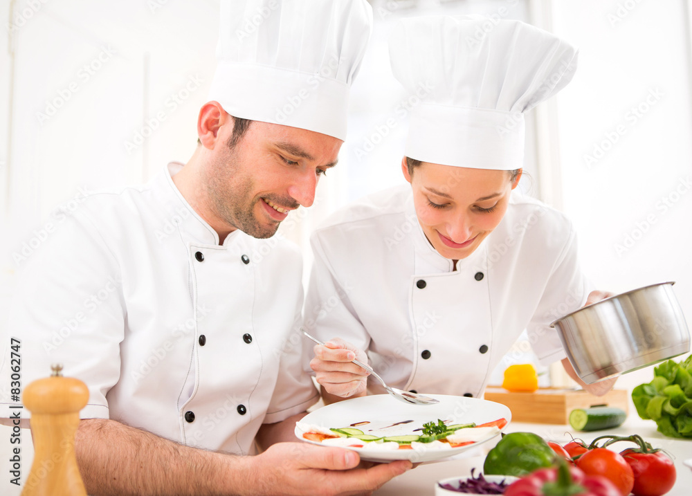 Young attractives professionals chefs cooking together