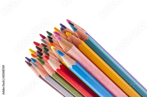 Colourful wooden crayons on white background.