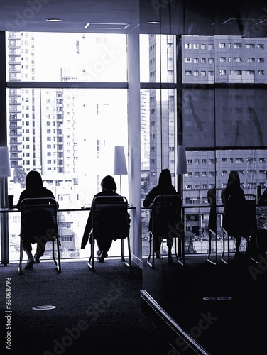 Silhouette of People Reading by the Window