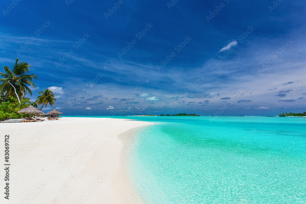 Palm trees over stunning lagoon and white sandy beach