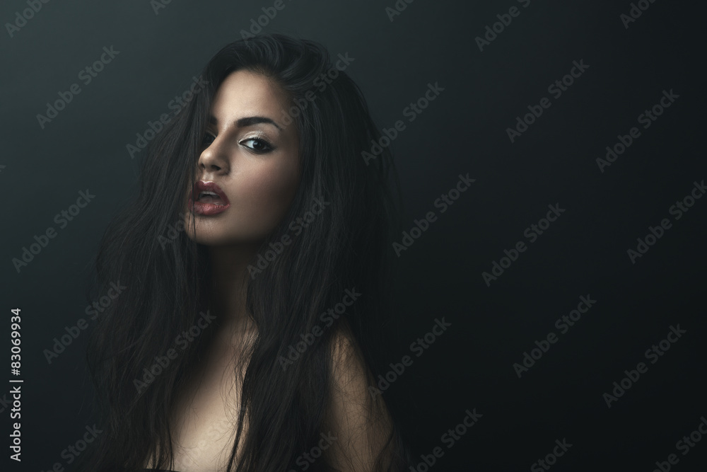 Obraz premium beautiful girl with tousled hair in darkness