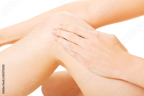 Woman touching her knee