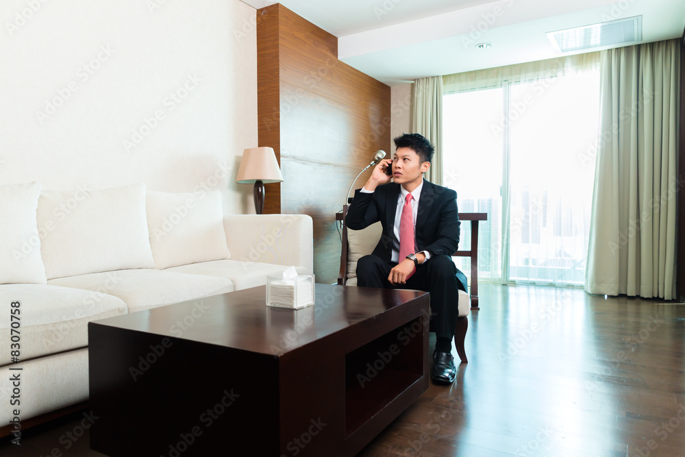 Chinese Businessman on business trip in hotel suite Chinese Businessman on business trip in hotel suite