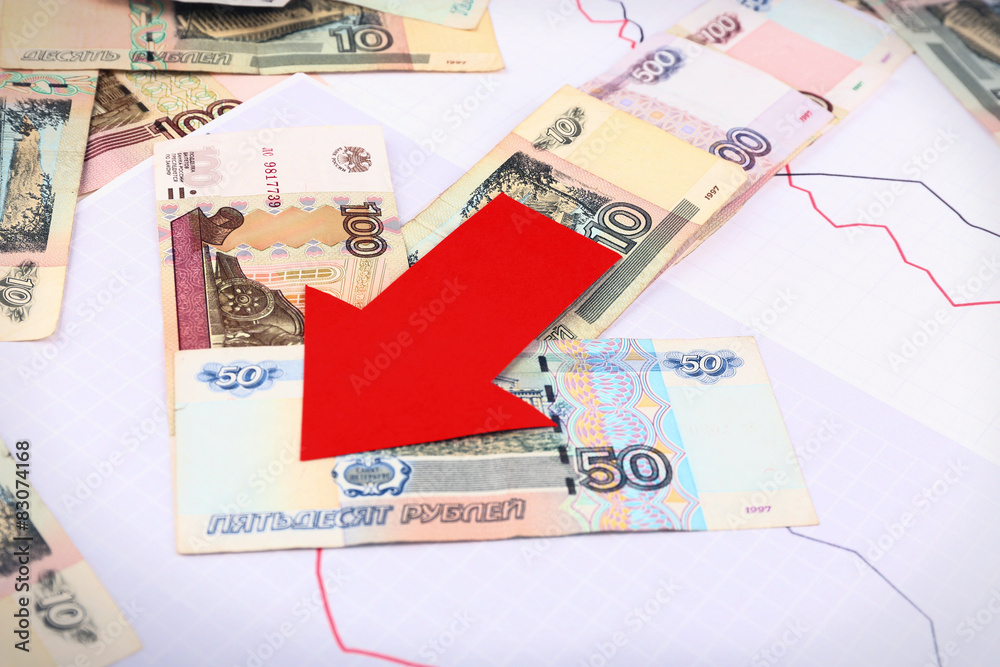 Money and red arrow on graph document close up Money and red arrow on graph document close up