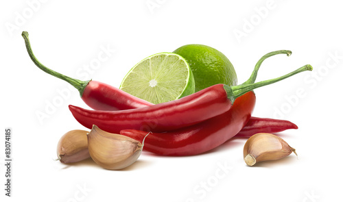 Red hot chilie pepper, garlic cloves, lime isolated on white