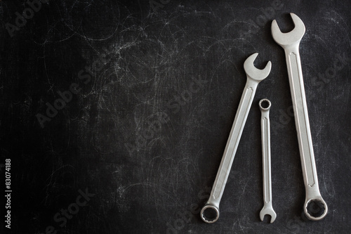 Set of 3 Wrenches on a Dark Textured Background