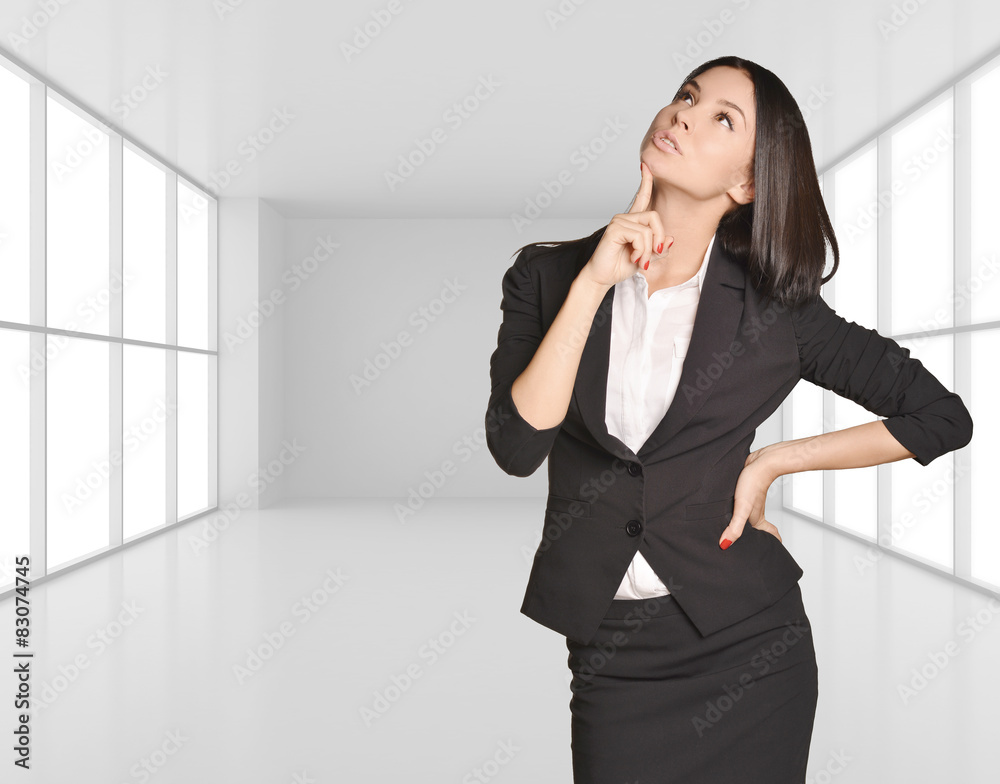 Young Girl standing on background of light interior with large Young Girl standing on background of light interior with large