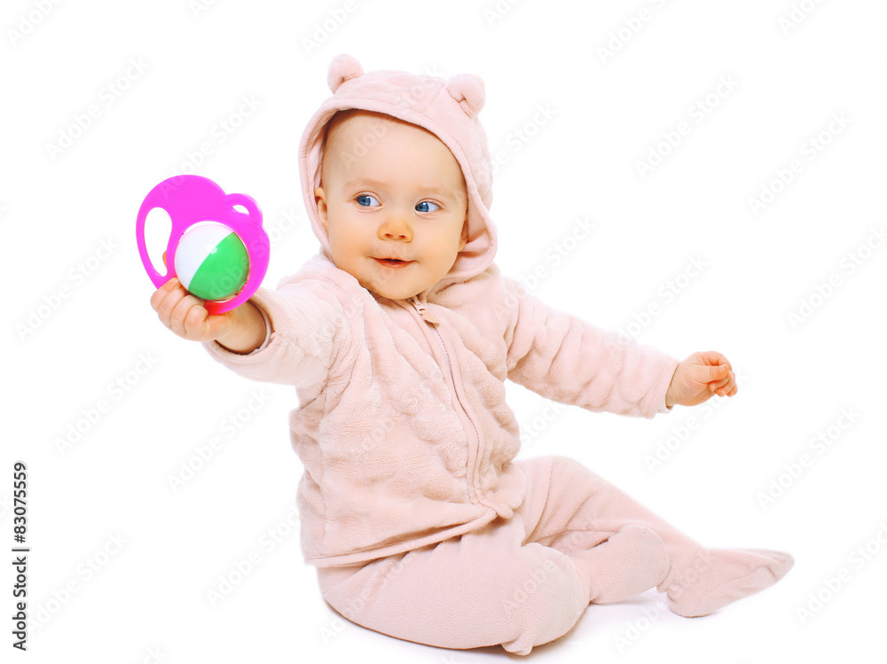 Funny baby sitting and playing with the rattle