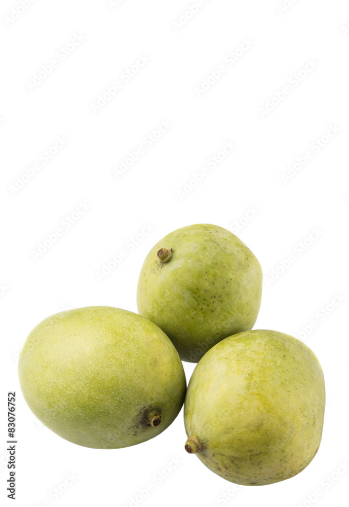 Green mango over wicker background Green mango over wicker background