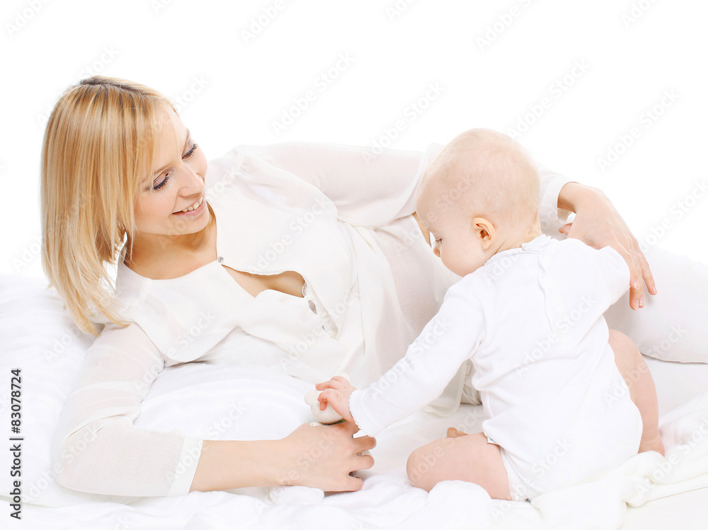 Young mother lying with her baby and playing Young mother lying with her baby and playing