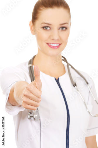 Medical doctor woman with thumbs up.