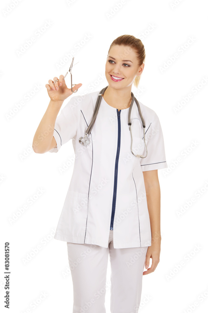 Female doctor with scissors in hand. Female doctor with scissors in hand.