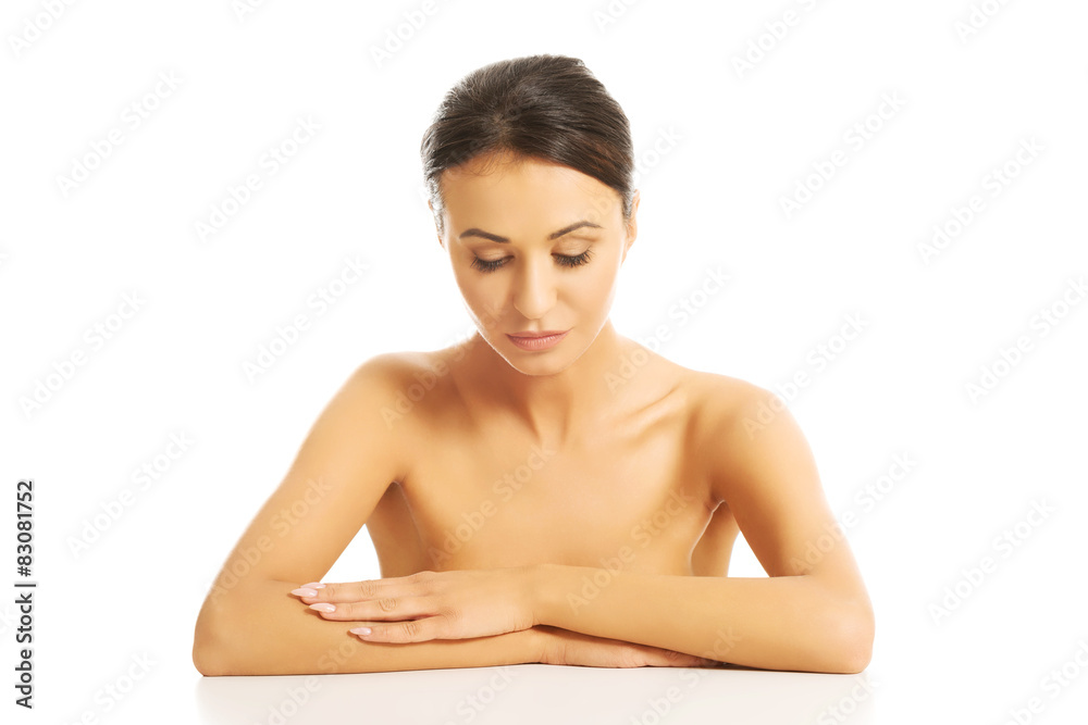 Spa woman sitting at the desk with folded arms Spa woman sitting at the desk with folded arms