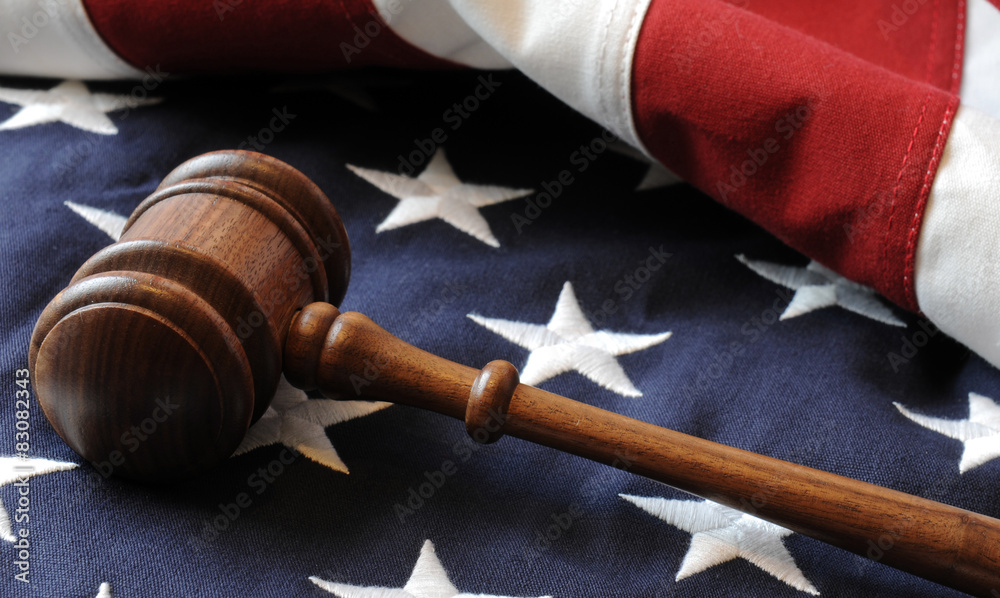 Wooden Judge's gavel and American flag