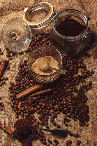Roasted coffee beans and scoop with milled coffee