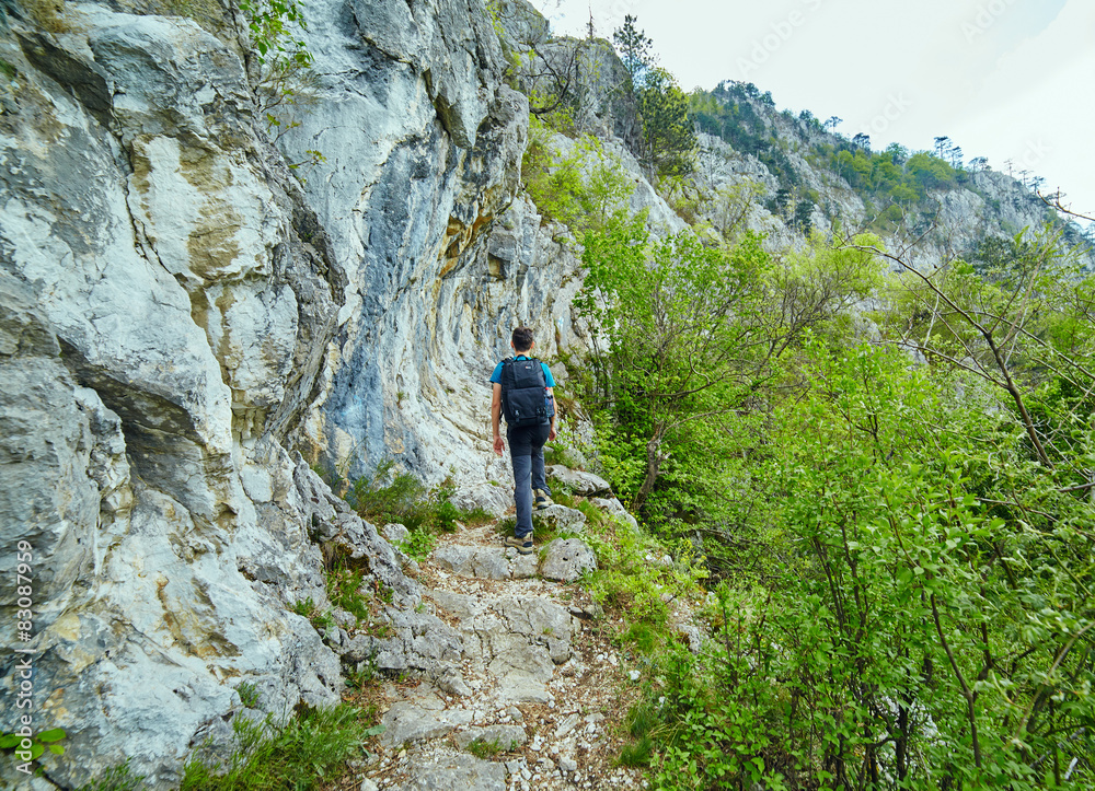 Teenager hiker on a mountain trail