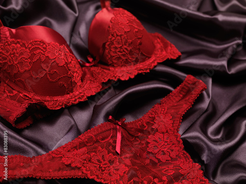 Dark red lacy lingerie on black background