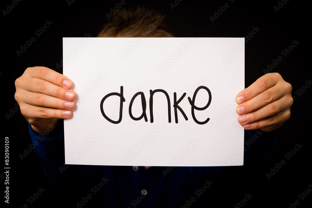 Child holding sign with German word Danke - Thank You