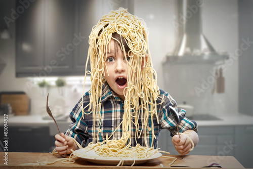 Surprised boy with pasta on the head photo