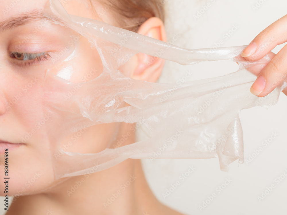 Naklejka premium girl removing facial peel off mask