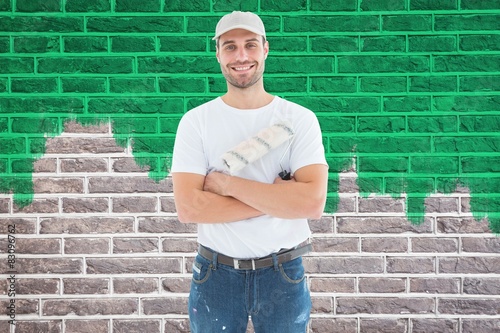 happy man with paint roller standing arms crossed