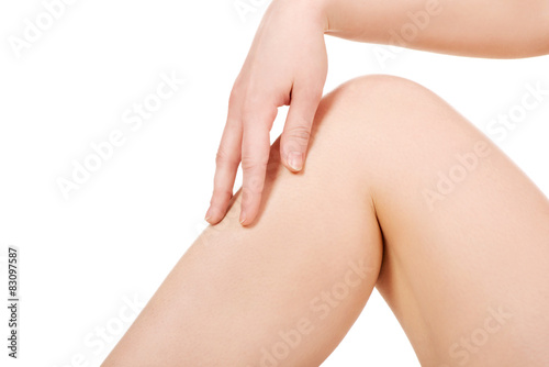 Woman touching her leg.