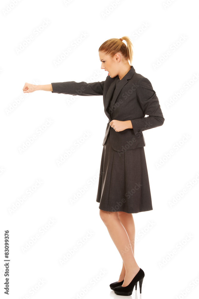 Businesswoman screaming and shaking her fist. Businesswoman screaming and shaking her fist.