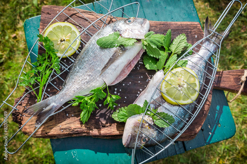 Photography Grilling fresh fish with herbs and lemon