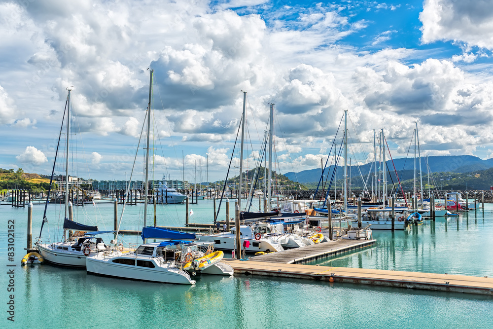 City pier with many sailing yachts