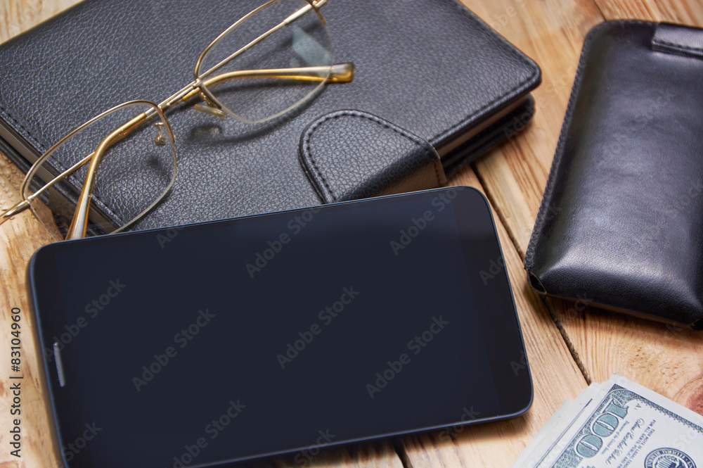 Workplace with notebook, phone, laptop, money, glasses. Workplace with notebook, phone, laptop, money, glasses.