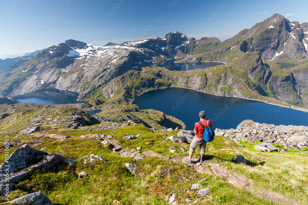 Naklejka premium Man takes rest on top of mountain in Norway