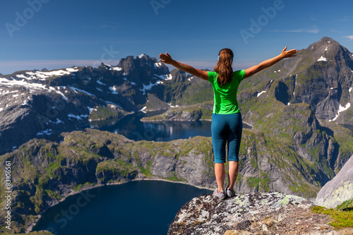 Woman takes rest on top of mountain in Norway