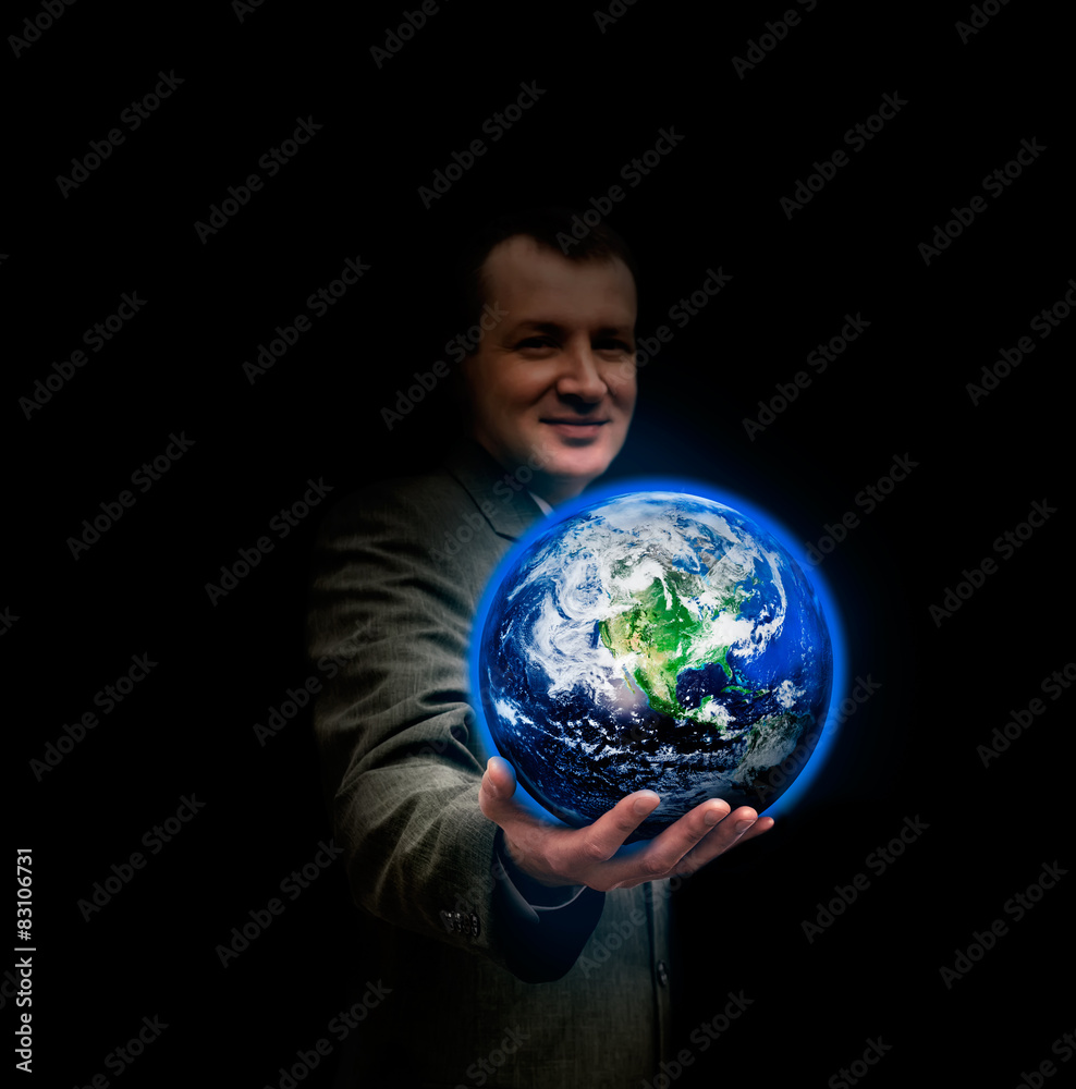 Young businessman holding in his hand a glowing earth globe Young businessman holding in his hand a glowing earth globe
