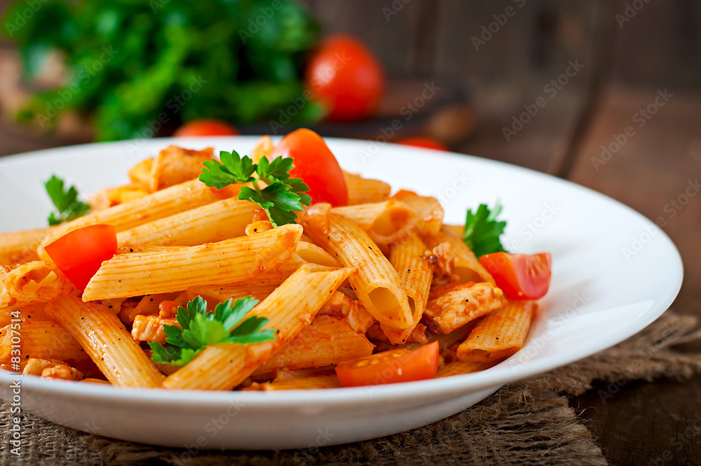 Penne pasta in tomato sauce with chicken, tomatoes Penne pasta in tomato sauce with chicken, tomatoes