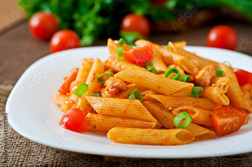 Penne pasta in tomato sauce with chicken, tomatoes