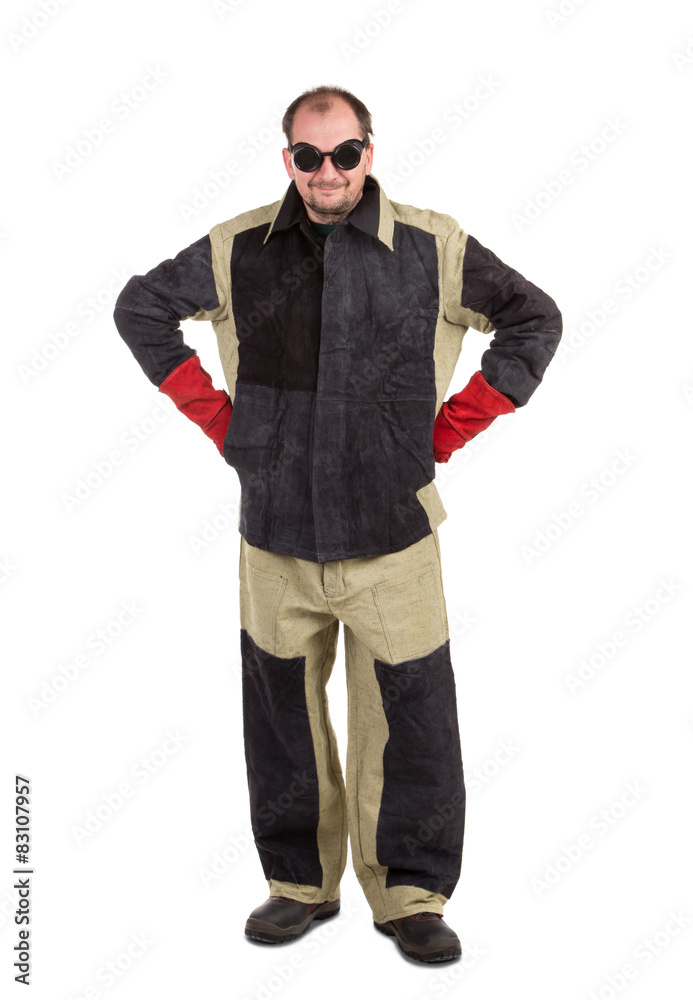 Welder in glasses with arms on waist. Welder in glasses with arms on waist.