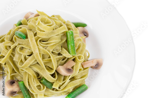 Pasta tagliatelle with green peas and ham.