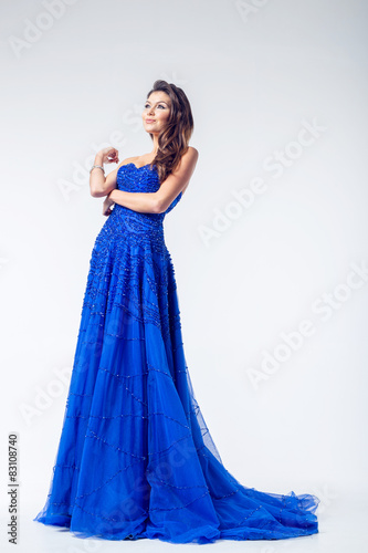 Fototapeta Young woman in a beautiful blue evening dress