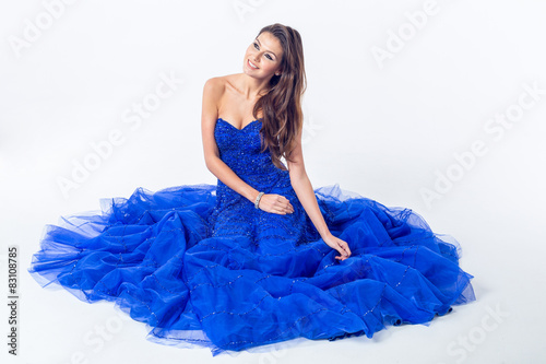 Young woman in a beautiful blue evening dress photo