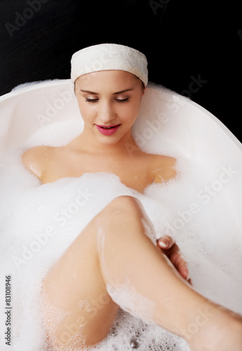 Bathing woman relaxing in bath.