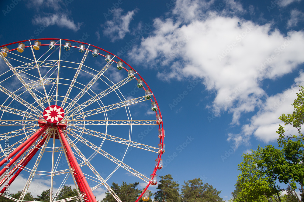 Atraktsion Ferris wheel against the blue sky