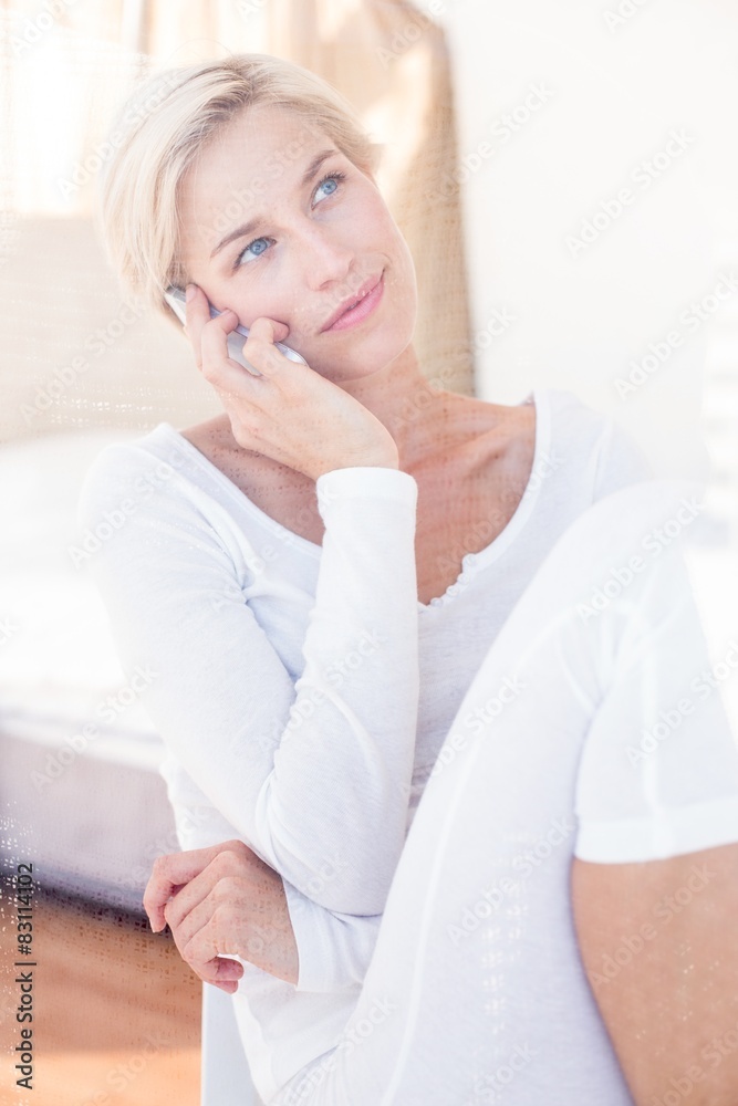 Smiling blonde woman calling on the phone Smiling blonde woman calling on the phone