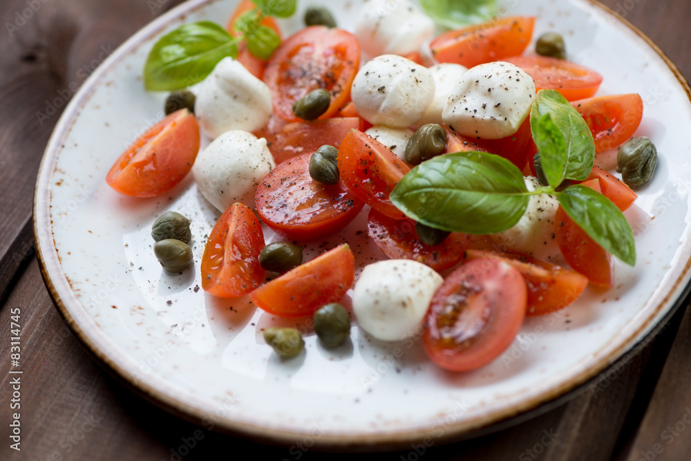 Close-up of caprese salad with capers, selective focus