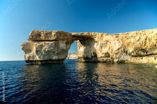 Azure Window, famous stone arch on Gozo island with reflection,